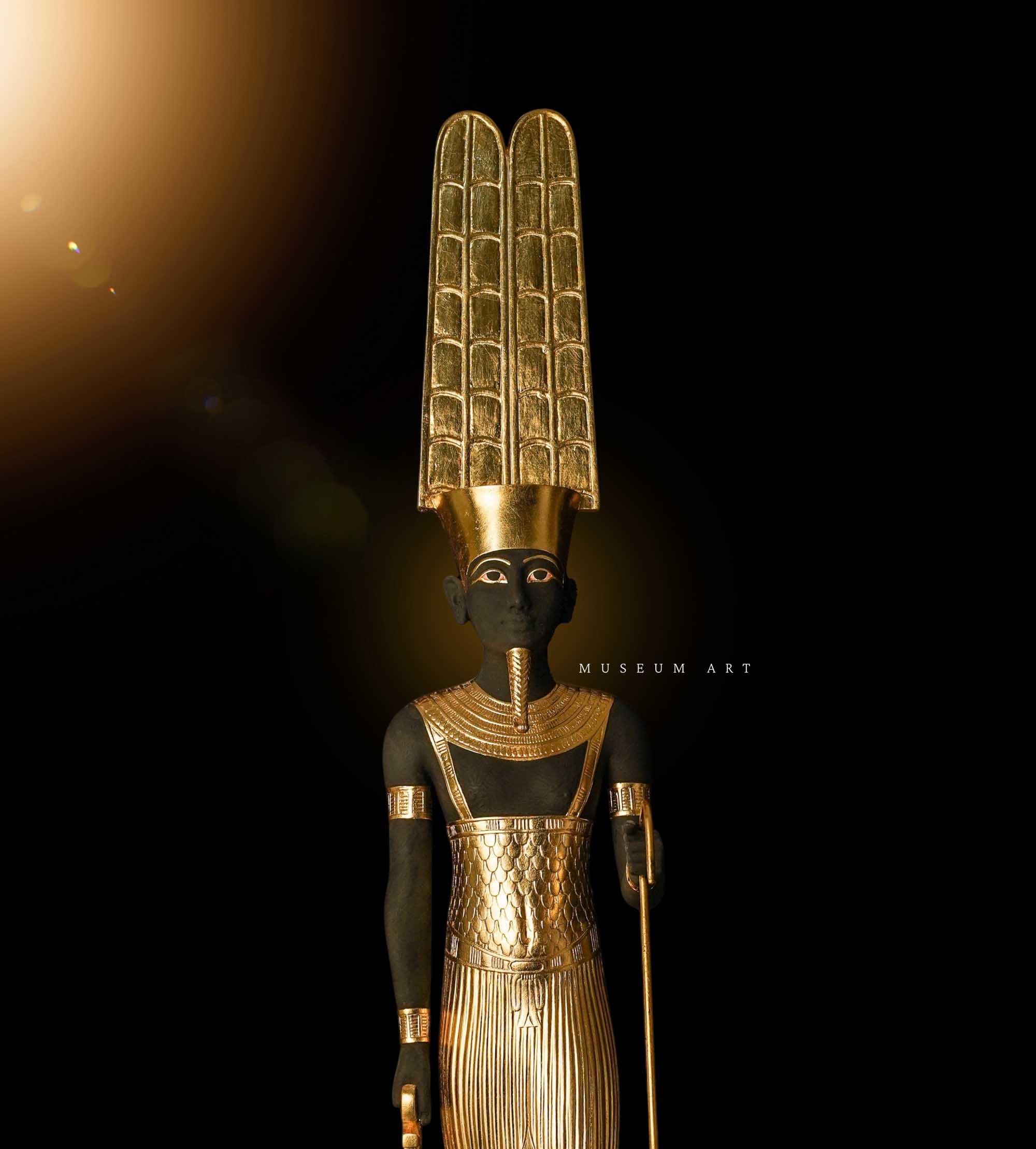 Large God Amun statue with his powerful staff.